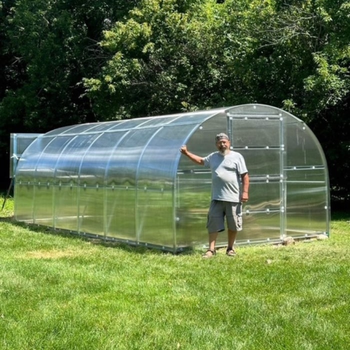 Polygrow polycarbonate greenhouse installed in a garden