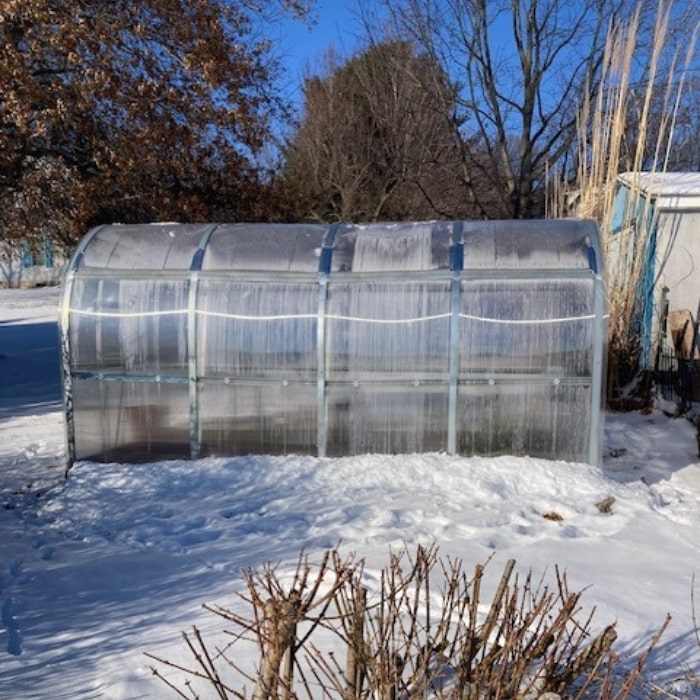 Polygrow polycarbonate greenhouse installed in a garden