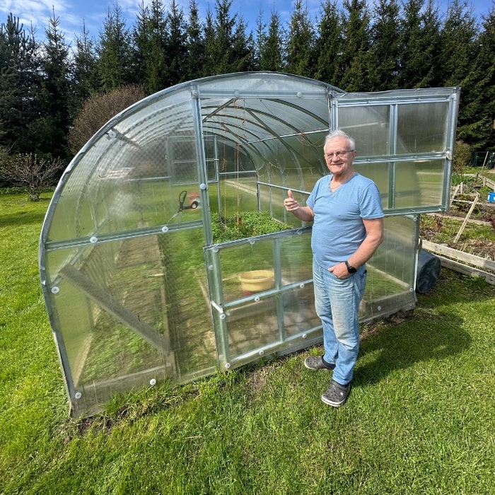 Polygrow polycarbonate greenhouse installed in a garden