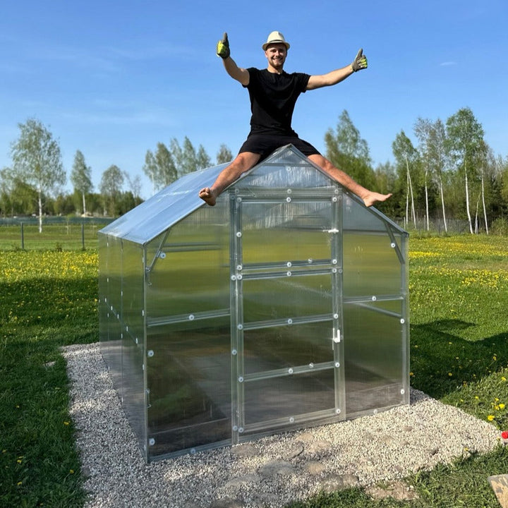 Polygrow polycarbonate greenhouse installed in a garden